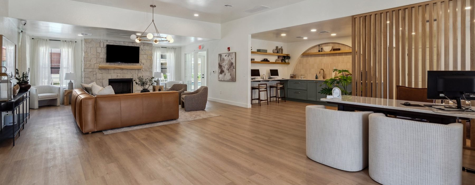 a clubroom with a tv, couch and computers
