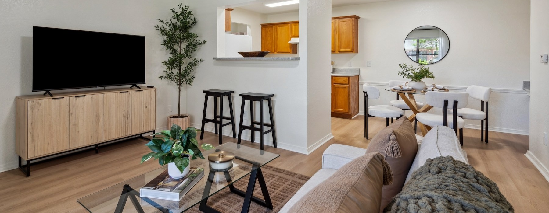 a living room with a tv, coffee table and a couch